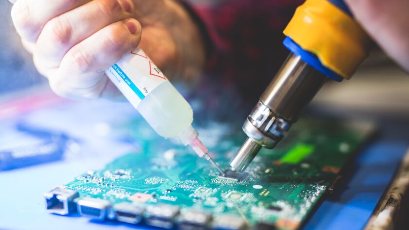 Man fixing electronic board