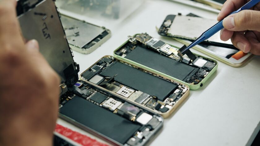 Repairman fixing smartphones